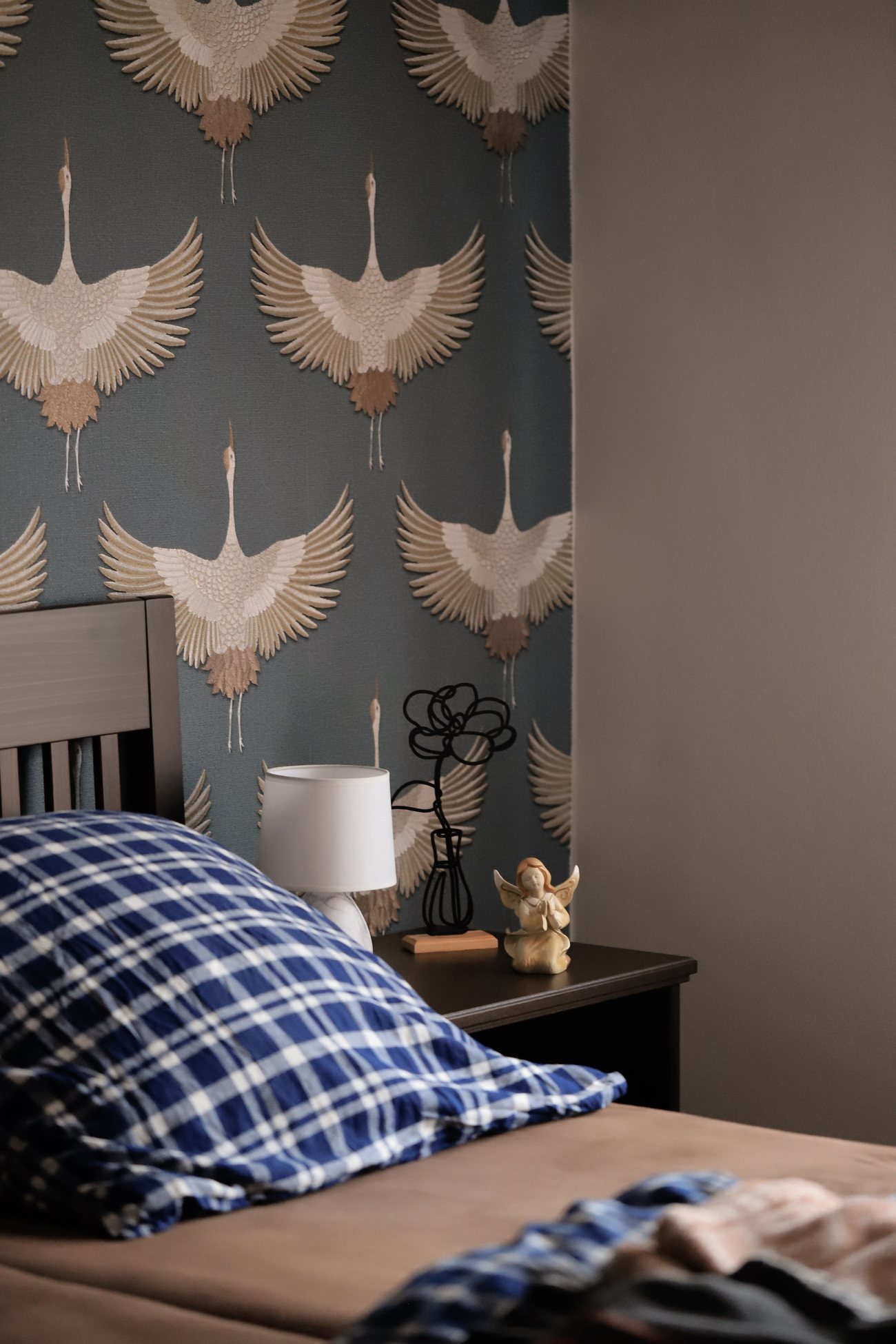 Bedroom feature wall finished in a hand-illustrated crane motif wallpaper