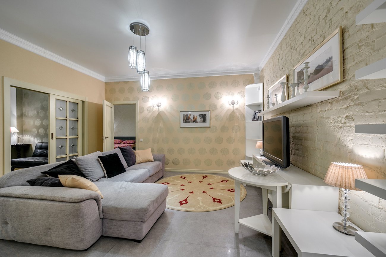 Full living room finished with a warm patterned wallpaper across every wall